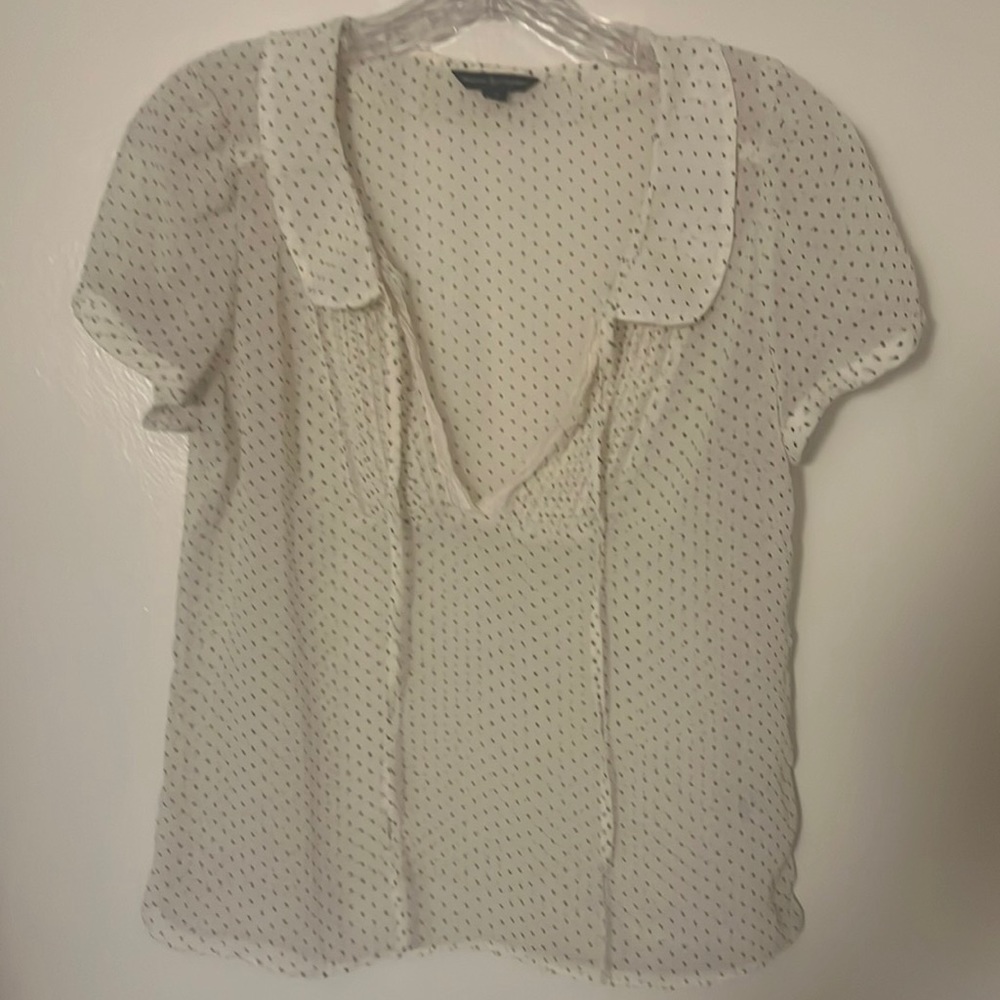 White with black polka dotted blouse.
